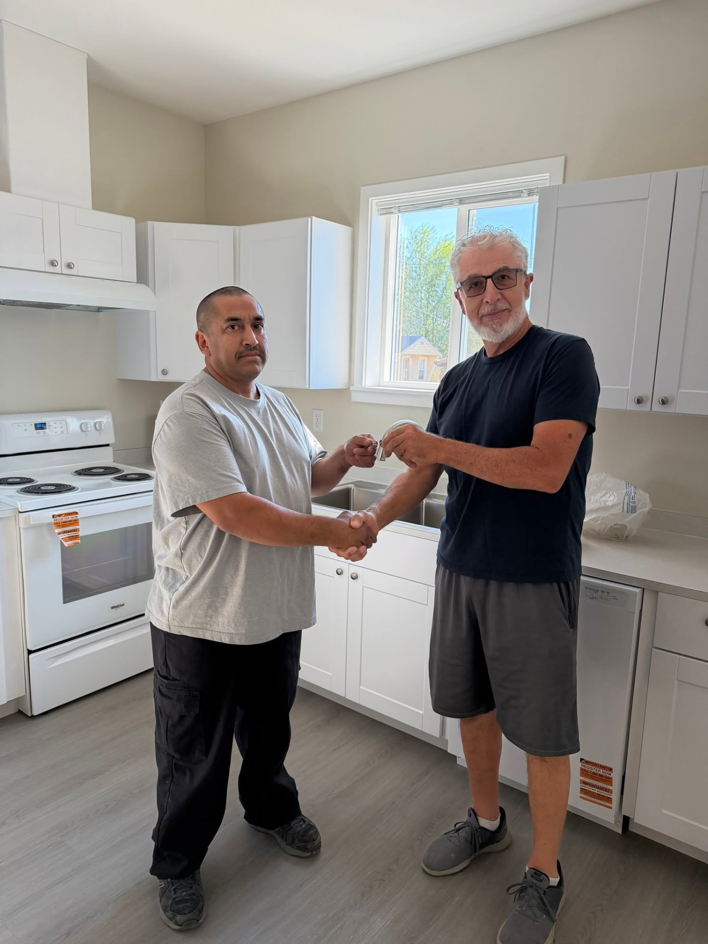 A new Habitat homeowner receiving the keys to their home